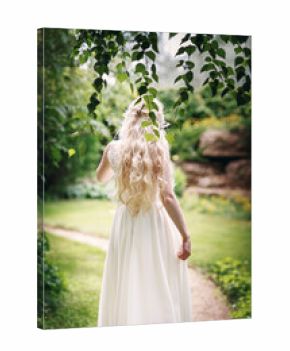 Bride with long fair hair from back in the garden