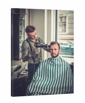 Confident man visiting hairstylist in barber shop.