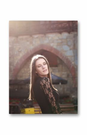 Tender brunette woman with closed eyes posing at the street