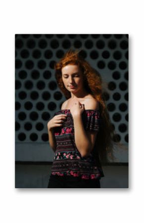 Lovely young red haired model with freckles. Woman with closed eyes posing with naked shoulders