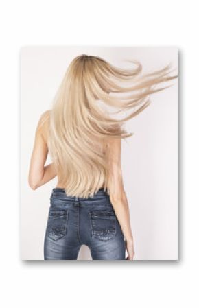 Flying healthy straight long blonde hair. Look from the back in motion.