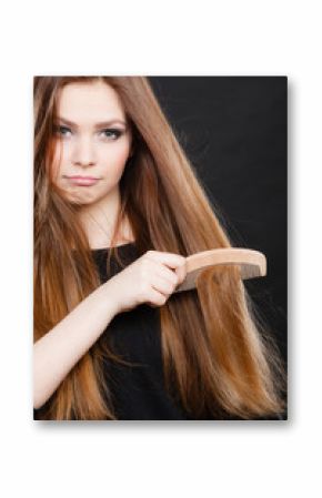 Long haired woman combing her hair.