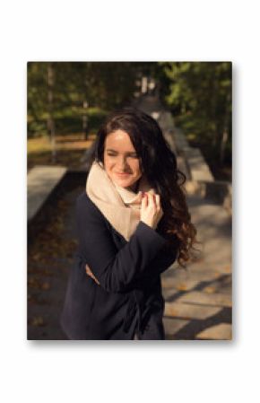 Urban portrait of pleased brunette model with long wavy hair walking on the street with stairs