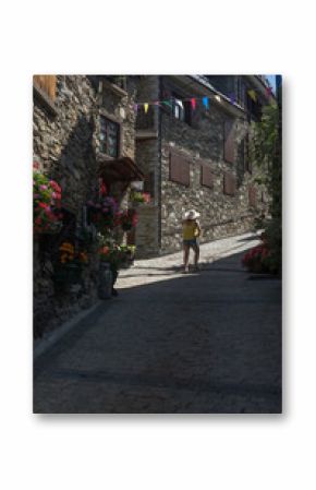 woman walking on foot a mountain village in spring in the Pyrenees
