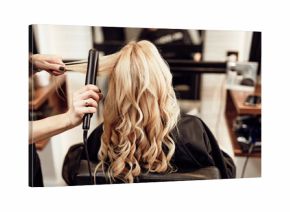 Beautiful hairstyle of blond middle-aged woman in modern hair salon...