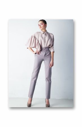 Beautiful woman in casual blue trousers and blouse posing
