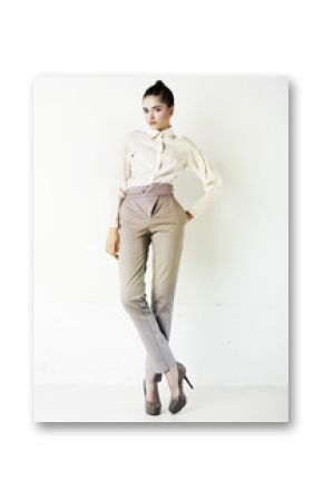 Young stylish brunette woman in white blouse and pants