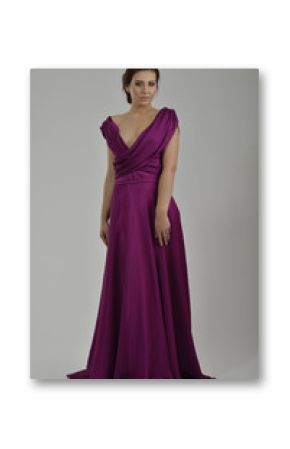 elegant woman in fashionable dress posing in the studio