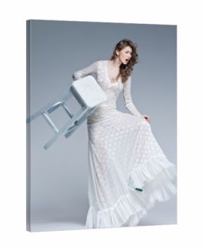 beautiful woman in long white dress posing fashion in the studio