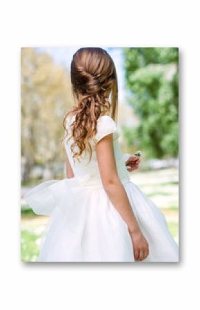 Girl in communion dress showing hairstyle.