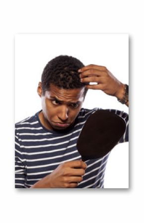 concerned dark-skinned young man settles himself in the mirror