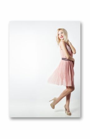 beautiful woman with bright makeup in pink dress with long legs