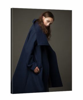 fashion model woman coat and hat urban style pose on color
