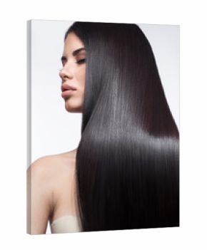 Beautiful brunette girl in move with a perfectly smooth hair, and classic make-up. Beauty face. Picture taken in the studio on a white background.