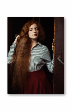 Beautiful young ginger model with closed eyes and curly red hair