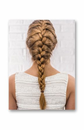 Head of a young woman from behind. Rear view braid