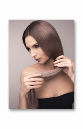 Vertical studio shot of a girl with long purple blonde hair.