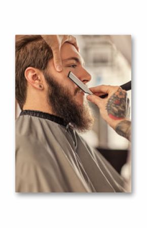 Barber with razor shaving.