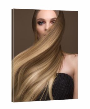 Beautiful blond girl with a perfectly smooth hair, classic make-up. Beauty face