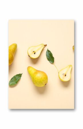 Ripe pears and leaves on yellow background
