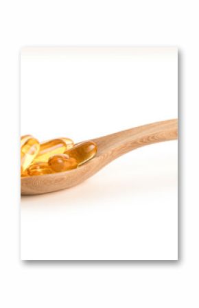 Fish oil capsules on wooden spoon isolated on white background.