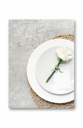Table setting with beautiful flower on grey background