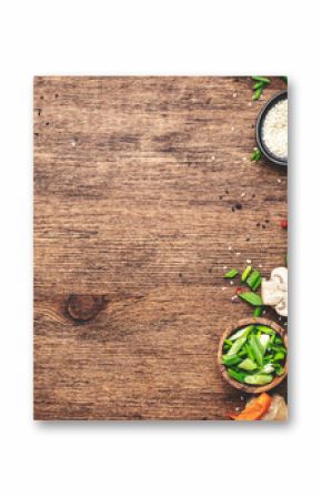 Food and cooking background. Wooden table with vegetables, spices and ingredients for preparing vegan Asian dishes with mushrooms and soy sauce. top view, copy space
