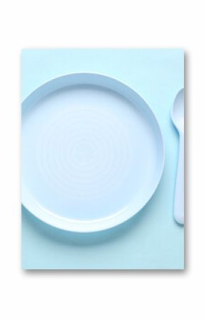 Plate with cutlery for baby on blue background