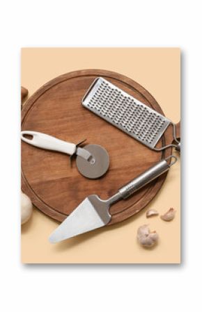 Composition with stainless steel pizza cutter, kitchen utensils, mushrooms and spices on color background