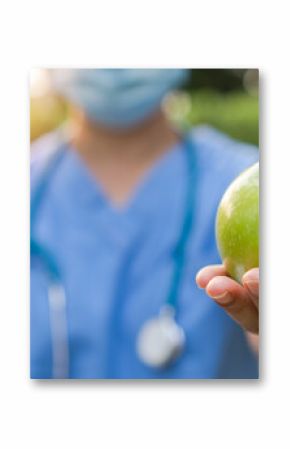 World health day, National nutrition week,an apple a day keeps the doctor away concept by eating high nutritious clean food and healthy nutritional diet with doctor handling green apple to patient