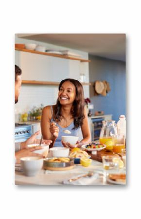 Multiethnic couple enjoying breakfast at home