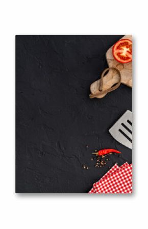Picnic flatlay. Steel barbecue utensils with tomatoes and greens, top view