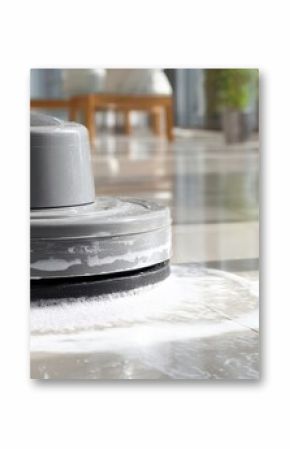 The professional floor scrubber performing a deep clean on shiny tiles.