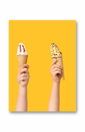 Female hands with different sweet ice-cream on yellow background