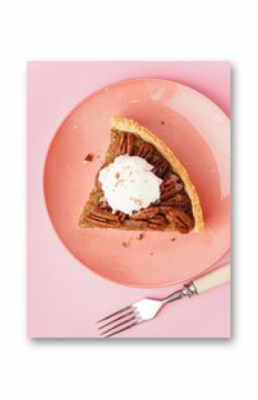 Plate with piece of tasty pecan pie on pink background