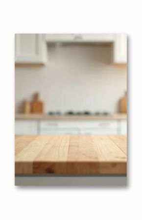 Empty wood table top in modern kitchen interior. Ready for product montage food presentation. Blurred clean bright background with white cabinets, decor, utensils, green plant in daylight. Wooden