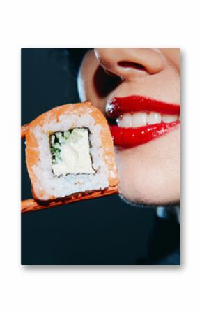 Bright and vivid close-up of a woman's smile with red lipstick, holding sushi with chopsticks, showcasing Asian cuisine and delightful emotions.