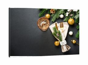 Modern golden cutlery and christmas decorations at black.