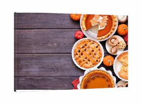 Homemade fall pie side border. Above view on a dark wood background with copy space. Assortment of apple and pumpkin pies.