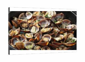 Steamed Clams with garlic, parsley and white wine in a cast iron pan