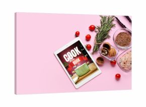 Digital recipe book and different ingredients on pink background