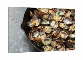 Steamed Clams with garlic, parsley and white wine in a cast iron pan