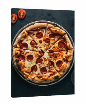 Pepperoni Pizza on Black Wooden Table with Tomato Pieces