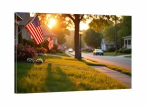 American flags fly on suburban street at sunset. Warm golden light shines on houses, lawns, trees, and cars driving by. Peaceful neighborhood scene.