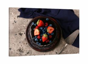 Sweet chocolate cake with fresh berries on grey background
