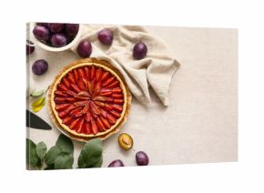 Plate with tasty plum pie, spatula and fresh fruits on table