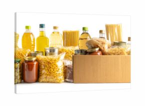 Foodstuff for donation, storage and delivery. Various food, pasta, cooking oil and canned food in cardboard box.