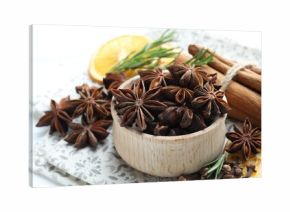 Different spices, dry orange slices and fresh rosemary for mulled wine on table, closeup