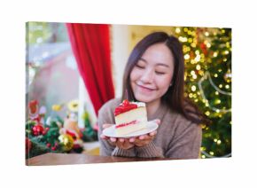 Portrait image of a woman holding a piece of cherry cake in Christmas holidays