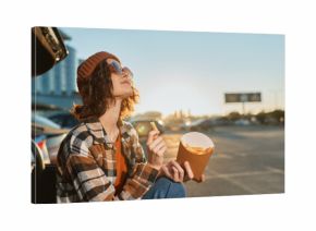 woman fries car sunset beanie sunglasses parking casual enjoying golden hour glow with authenticity and candid lifestyle vibe, mindful living and emotional storytelling in urban roadside scene